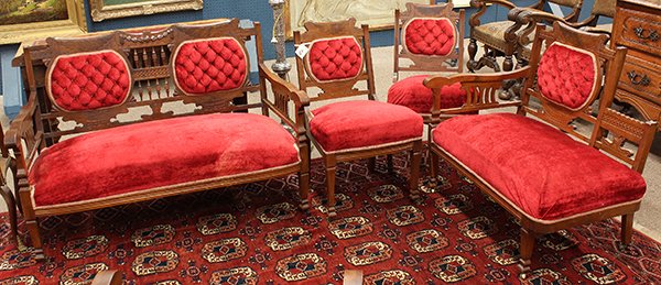 Eastlake parlor suite in red upholstery: (lot of 6) American Eastlake parlor suite, executed in walnut circa 1880, each covered in red upholstery and rising on square tapered legs ending on casters, consisting of a settee 34"h x 50"w, recami