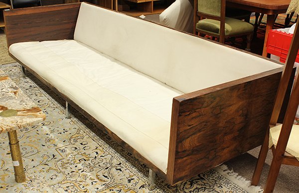 Rosewood case sofa: Mid Century rosewood sofa attributed to Milo Baughman, the rosewood even arm form having cream canvas upholstery and rising on square chrome legs, 24"h x 96"w. x 33"d.