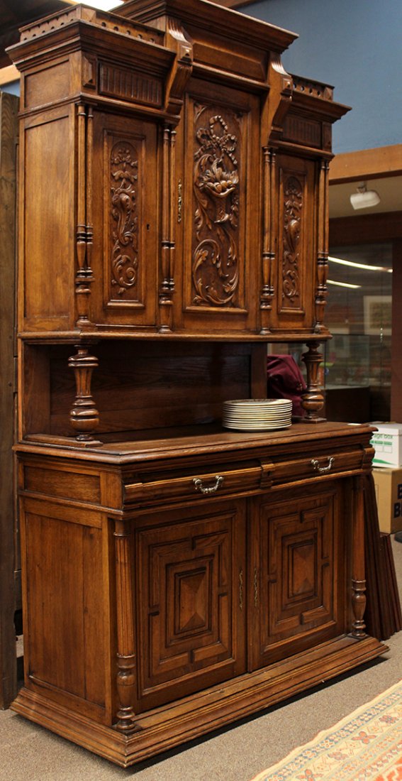Henry II style carved oak buffet: Henry II style carved oak buffet, circa 1890, the three door superstructure with carved swag and ribbon decorated panels, the lower case with raised paneled fronts flanked with the turned pilasters, a