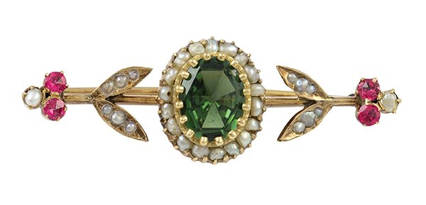 Victorian Russian yellow gold brooch: Victorian gemstone and 14K yellow gold brooch centering one oval cut green tourmaline weighing approximately 2.30 cts., accented by natural pearls and (4) rose cut red spinels. Russian Hallmarked 56 f