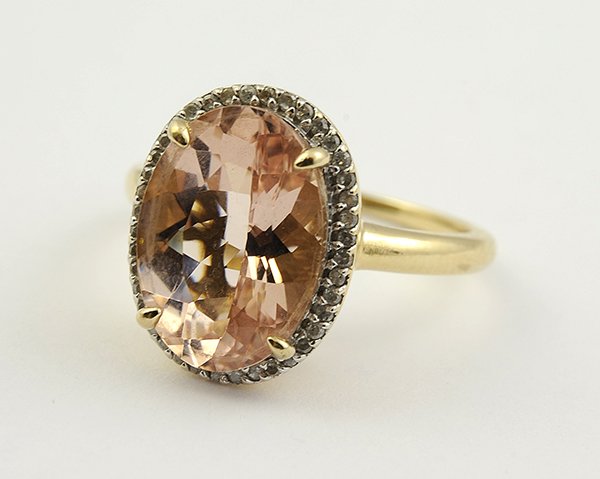 Morganite diamond yellow gold ring: Morganite, diamond and 14K yellow gold ring featuring (1) oval cut morganite weighing approximately 8.00 cts., accented by (41) single cut diamonds totaling approximately 0.20 ct., set in a basket mou