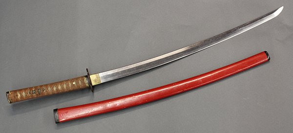Japanese Katana with 16-17c Tsuba: Japanese katana (sword), the tang marked Hidetoshi, together with an iron tsuba from Momoyama/early Edo period, red lacquered wood saya (scabbard), hacho (blade length) : 26.5"