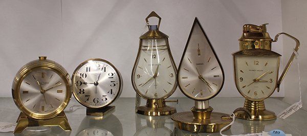 Swiss novelty desk/alarm clocks: (lot of 5) Swiss novelty desk/alarm clocks consisting of two by Phinney-Walker, one having a lighter at top, two by Swiza Sheffield having barrel forms, and one of jewel from by Swiza