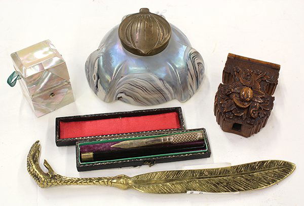 Group of table accessories: (lot of 5) Group of table accessories including a talon form page turner, a mother of pearl perfume bottle, an Art Nouveau art glass inkwell, a cased fountain pen, and a carved wood case