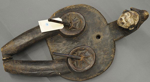 Punu Society, Gabon carved figural door: Punu style, Gabon carved bellows surmounted by a pigment decorated traditional female mask continuing to a zoomorph form body, 32"h x 17"h (losses)