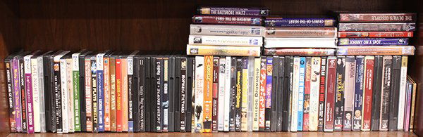 One shelf of mostly DVDs: One shelf of mostly DVDs including Casablanca, Hitchhikers Guide to the Galaxy, etc.; together with (14) tapes