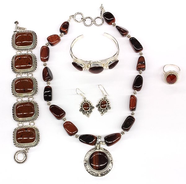 Collection of gemstone and sterling silver jewelry: Collection of gemstone and sterling silver jewelry featuring one faceted carnelian sterling silver ring, size 10; one large red jasper, sterling silver bracelet, length 7"; one red jasper, sterling si