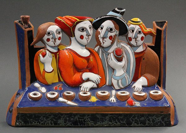 Russian judaica menorah by Katya Apekina: Russian Judaic menorah by Katya Apekina (Russian b. 1959) circa 1993, executed in ceramic with polychrome enamel, depicting figures in medieval dress seated at a feast table with (8) candle holders pl
