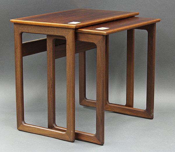 Danish modern nesting tables: (lot of 2) Danish Modern nesting tables, executed in rosewood with rectangular tops, each having contrasting banding and rising on conjoined legs, retains original Danish label and brand, tallest 18"h