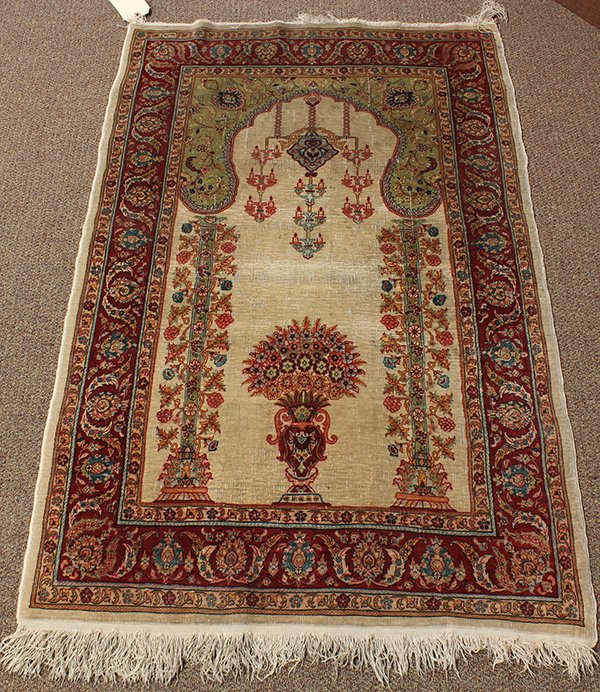 Turkish part silk prayer rug: Turkish part silk prayer rug, circa 1900, having an architectural mihrab with multiple lanterns above vine wrapped columns flanking a vase with flowers, with pale green spandrels and rosette border on