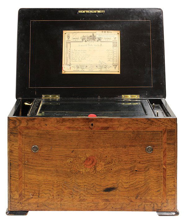 Inlaid Swiss music box: Inlaid Swiss music box, circa 1890, the large form with double combs, accordion keys at center, that accommodate an 11" cylinder that plays six tunes, below with accordion bellows, the marquetry decor