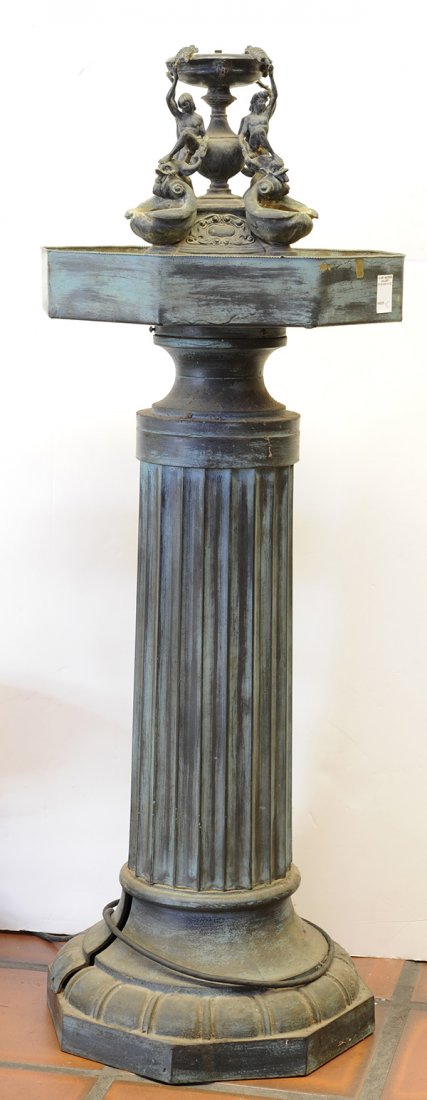 Renaissance style bronze, copper, and patinated metal: Renaissance style bronze, copper, and patinated metal fountain, the figural decorated top with four figures, each embracing a sea creature resting its head on the shell form reservoirs, surmounting th