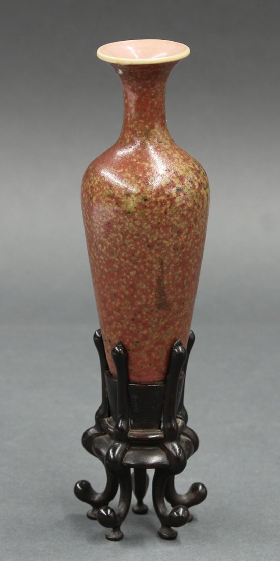 Chinese Small Peach Bloom Vase, Kangxi: Chinese peach bloom glazed small porcelain amphora vase, Qing dynasty, with a trumpet mouth above a long tapering body green mottled red exterior, the deep recessed base with an underglaze blue Kangxi