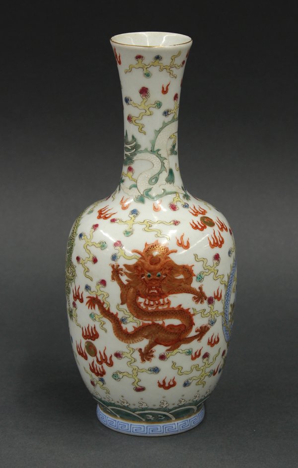 Chinese Stick Neck Dragon Vase: Chinese enameled stick neck porcelain vase, Republic period, featuring four meandering dragons amid stylized clouds, one yellow, orange, white and blue, the base with an apocryphal underglaze blue Qia
