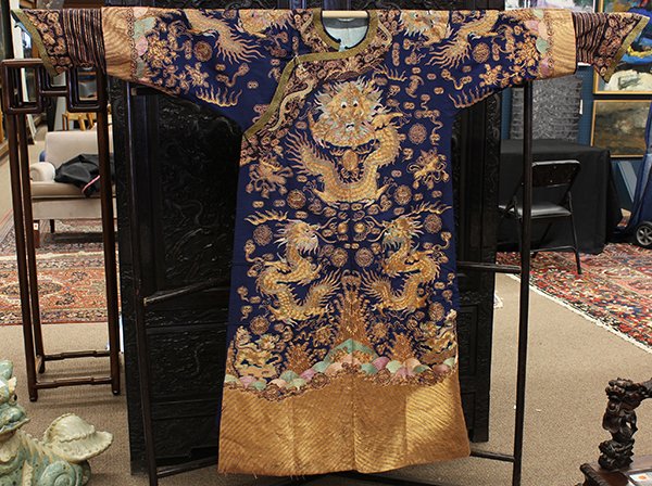 Chinese Couched Blue Dragon Robe: Chinese couched blue ground dragon robe, featuring nine mang-dragons executed in gilt wrapped and color threads along with shou medallions and clouds, the lower section with fu-lions standing on lingz
