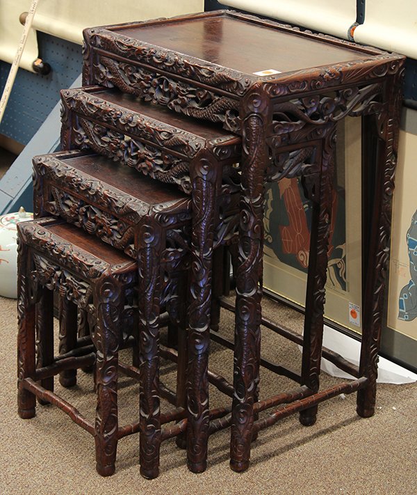 Chinese Nesting Tables, Dragons: Set of four Chinese export nesting tables, of graduated sizes, the edges and supports carved with meandering dragons amid clouds, 27.75"h x 19.5"w x 14.125"d