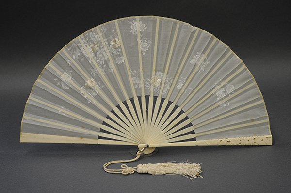 Asian decorative items: (lot of 4) Asian decorative items including an ivory/bone fan, bone tape measure having a figural decorated frieze, and erotic figural dice