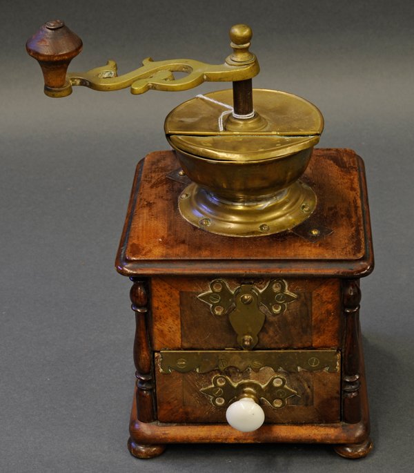 English style brass coffee grinder: Continental, circa 1900, brass coffee grinder, mounted in a wood box, the urn shaped hopper with base and wood knobbed crank handle 12"h overall