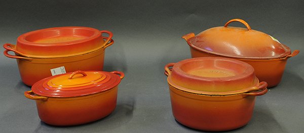 Associated enameled cast-iron cookware: (lot of 4) Associated enamel cast-iron cookware, consisting of (2) dutch ovens with lids in different sizes, one marked 'Made in Belgium' and (2) Doufeu dutch ovens, all are in shades of orange.