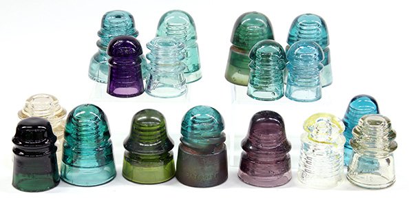 Collection of vintage glass insulators: (lot of 17) Glass insulator group, originally used for telegraph or telephone poles, executed in various colors including aqua, purple, teal, clear etc.