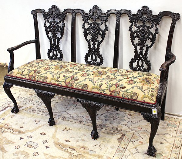 Chippendale style mahogany settle, in the New York: Chippendale style mahogany settee, circa 1920, executed in the New York taste, the three part back with intricately carved and pierced crests and splats, above a skirt with gadrooned edge and rising o