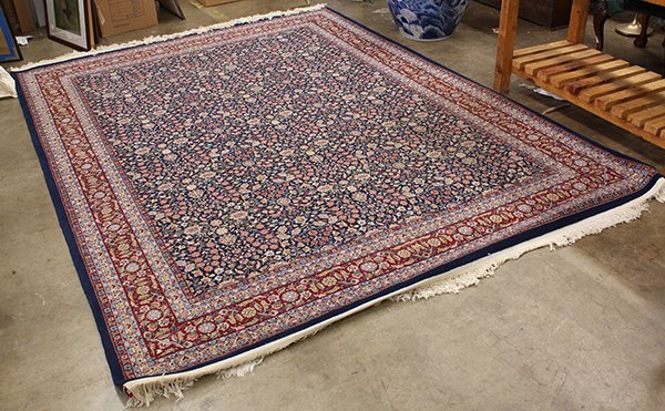 Turkish Hereke carpet,: Turkish Hereke carpet, having all over floral motifs on navy ground with alternating rosette border on rust, 11'1"l x 8'1"w.