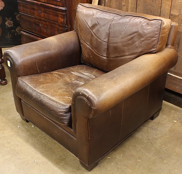 Chocolate brown leather club chair: Chocolate brown leather club chair rising on square feet, 34"h x 37"w x 36"d.