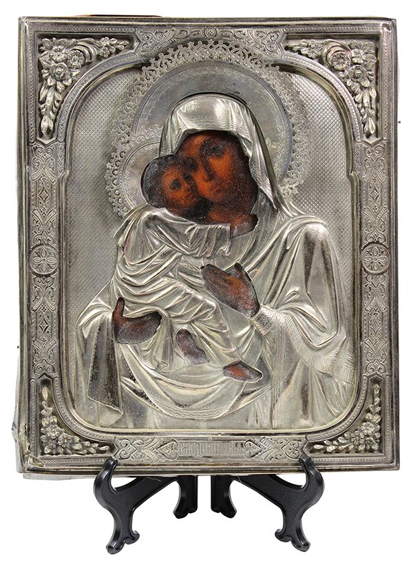 (lot of 2) Russian icon group: (lot of 2) Russian icon group, the larger depicting the mother of God, Vladimirskaia, the oklad having floral reserves and date marked 1891, the halo hallmarked for Andrei Tchulkov, 1895, 84 purity, 1