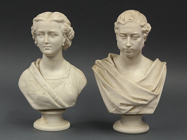 Copeland parian busts of man and woman in classical: (lot of 2) Copeland parian busts of a Classical male and female, 19th century, dressed in traditional attire, each rising on a circular pedestal form base, and impressed: "Copeland, Crystal Palace Art