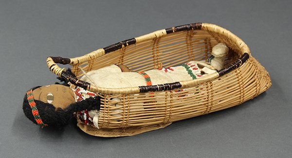 Native American, Hupa hand crafted beaded doll cradle: Native American, Hupa hand crafted beaded doll cradle with doll dressed in leather outfit and having high top mocassins, 12"h x 5"w x 2.5"d