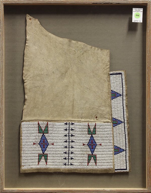 Native American framed beadwork and hide fragment: Native American framed beadwork and hide fragment, possibly from a saddle, the polychrome beaded border having abstract geometric designs, 24" x 19" overall