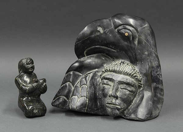 Inuit soapstone carvings: (lot of 2) Inuit soapstone carvings, one depicting a raven above a ladies face, signed Francis Ruben, 10"h; the other a seated figure of a lady holding a bird, 5.5"h. Provenance: Property from the col