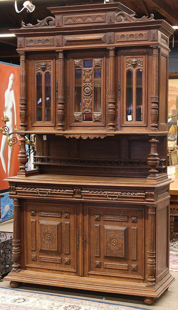 Henri II oak buffet: Henri II oak buffet, the superstructure with columnar pilasters fronting the three doors, the lower case with raised panels and rising on compressed ball feet, 97"h x 55"w x 21"d