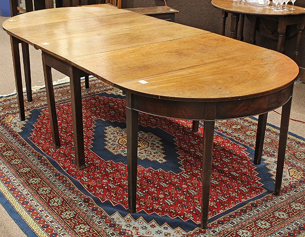 Federal three part D-end dining table: Federal three part D-end dining table, first quarter 19th century, executed in walnut, with two demi-lune ends flanking the center drop leaf, each having a single board top, and rising on square taper