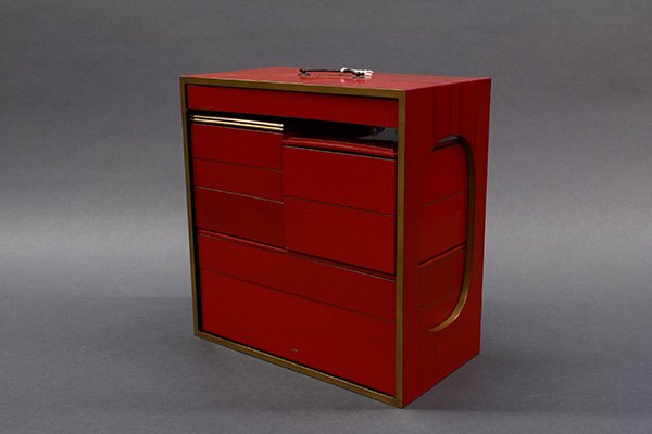 Japanese Lacquered Sage Jubako: Japanese lacquered wood sage-jubako (portable multi-tiered food boxes), vermilion red with gilt accent, consisting of a carrier and eight compartments, one of which is for sake, 11"h x 11"w x 6"d