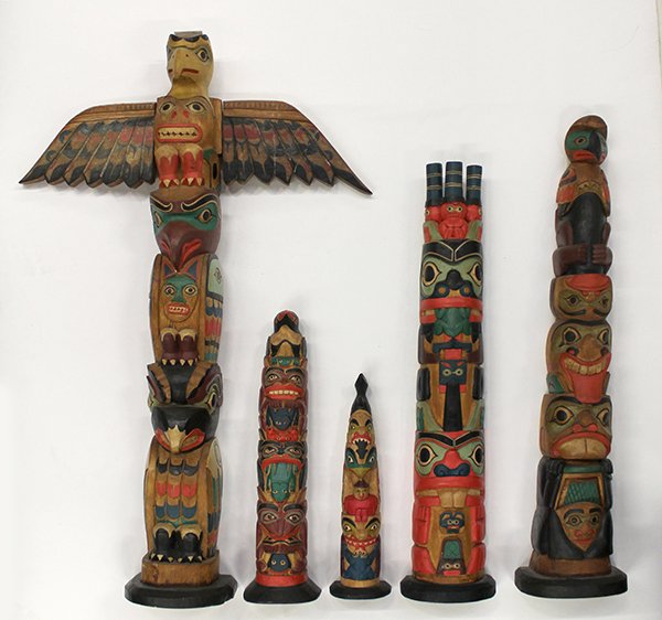 Northwest coast style carved and polychrome painted: (lot of 5) Northwest Coast, Native American carved and polychrome painted totems on bases, largest, 25"h. Provenance: Property from the collection of the Dr. Mary Anne Warren Estate