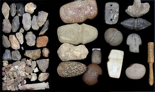 Pre-historic Native American stone tools: (lot of 40 plus) Pre-historic Native American tools including a double point war club head, a ceremonial ax head, a double hole gorget, several scrapers, and flint shards Provenance: Property from the
