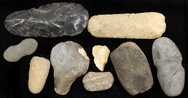 Prehistoric carved stone tools: (lot of 9) Pre-historic Native American carved stone tools including ax heads, pounders, scrapper, and knapped flint, largest 6"l.