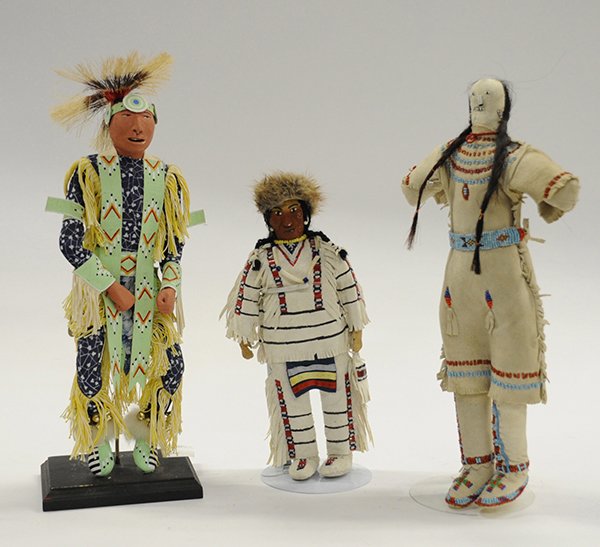Native American Sioux dolls: (lot of 3) Native American dolls including a late 19th/early 20th century cloth Sioux female traditionally dressed in beaded leather, 15.5"h; Sioux male "fancy dancer" doll with hair roach head dress