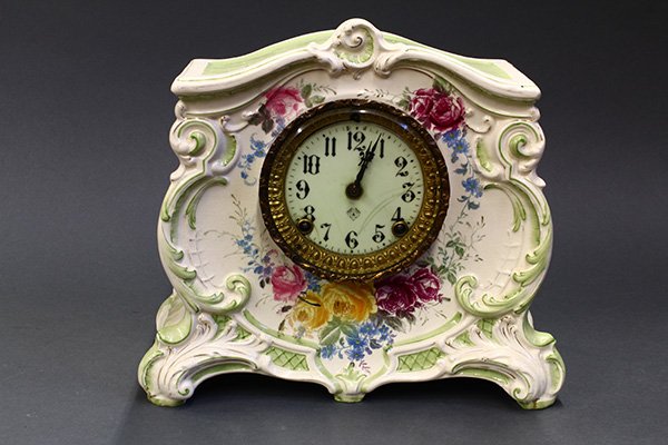 Royal Bonn porcelain mantel clock,: Royal Bonn porcelain mantel clock, having enameled tin dial and hand painted flowers, and Ansonia movement, 11"h x 12"w.