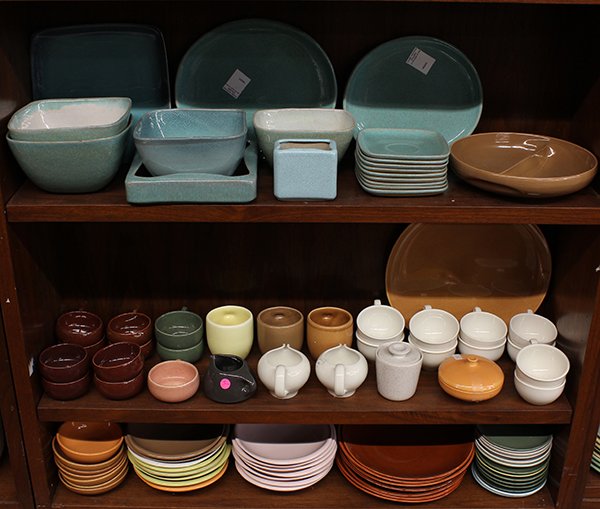 Russel Wright "Iroquois" pottery tableware: (lot of approx 92) Three shelves of Russel Wright "Iroquois" associated pottery tableware in turquoise, white, brown, pink, green, and orange includng serving bowls cups, saucers, dinner plates, and b