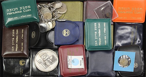 Israeli and European coins and medals,: (lot of 33) Israeli and European coins and medals, including a charm bracelet with a sterling typewriter and numerous coins from European countries mostly dating to the 1960's, Israeli silver commemor