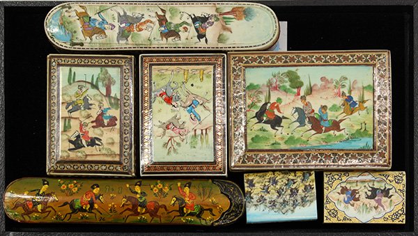 Mughal style inlaid boxes: (lot of 7) Mughal style inlaid boxes having polychrome decorated reserves depicting polo players, including (2) Persian papier mache pen boxes, and (3) Middle Eastern style wood examples, largest 1.5"