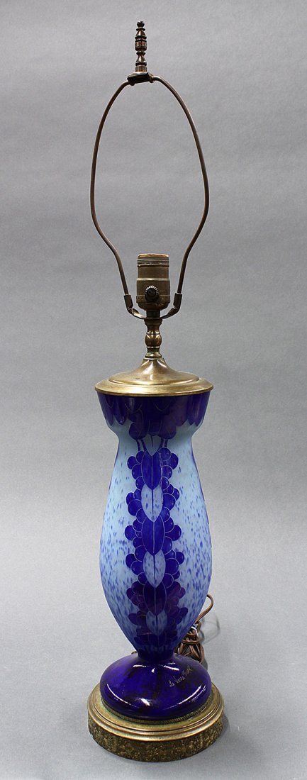 Le Verre Francais cameo glass lamp base: Le Verre Francais cameo glass lamp base, of baluster form in acid cut cobalt blue on a mottled ground, decorated with stylized geometric reserves, and rising on a circular foot and mounted on a gilt m