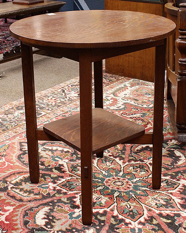 Stickley Brothers Arts and Crafts quartersawn oak lamp: Stickley Brothers Arts and Crafts quartersawn oak lamp table, model 2504, circa 1910, the circular top surmounting a lower shelf supported by cross stretchers with thru-tenon construction, and rising 