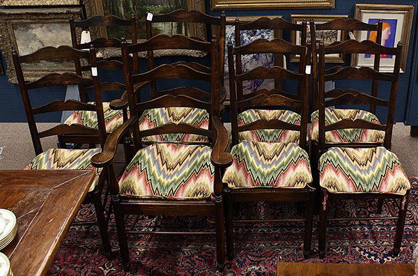 (lot of 8) Georgian style dining chairs: (lot of 8) Georgian style dining chairs, each having a shaped ladder back continuing to the rush seat with upholstered cushion, and rising on turned legs, consisting of two armchairs: 45"h x 25.5"w x