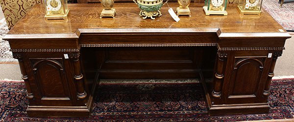 Large Renaissance Revival quartersawn oak sideboard: Large Renaissance Revival quartersawn oak sideboard, circa 1870, the shaped top, above the conforming two door case having carved columnar supports, and opening to a fitted interior, centering the sin
