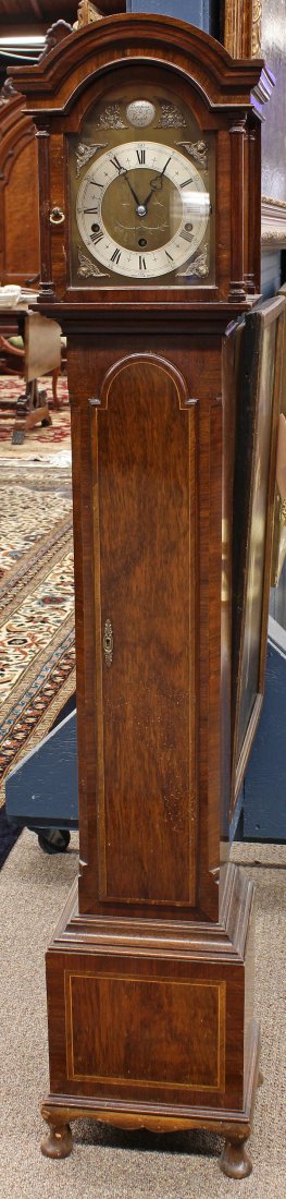 English Elliott of London walnut grandmother clock: English Elliott of London walnut grandmother clock, the domed case surmounting the Roman numeral dial, housed in a walnut two door case having stringing, and rising on turned legs, 53.5"h x 9"w x 8"d.
