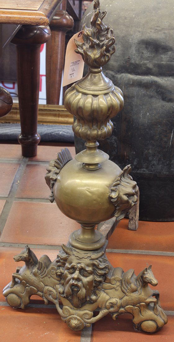 Pair of patinated metal fireplace andirons: Pair of patinated metal fireplace andirons, 19th century, the flame final surmounting the shaped standard continuing to the footed base centered with a figural medallion, 33"h Provenance: From the est