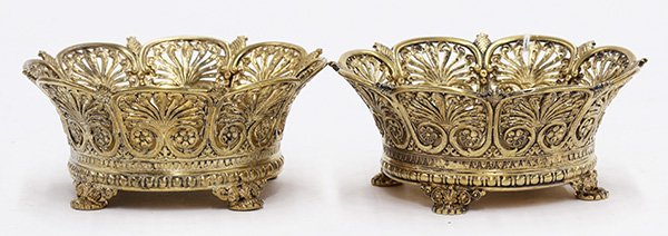 Pair of Tiffany & Co. sterling silver-gilt cachepots: Pair of Tiffany & Co. sterling silver-gilt footed cachepots, each with an openwork repousee fanning acanthus scroll and rosette border interspersed by pineapple accents, rising on confirming feet, one